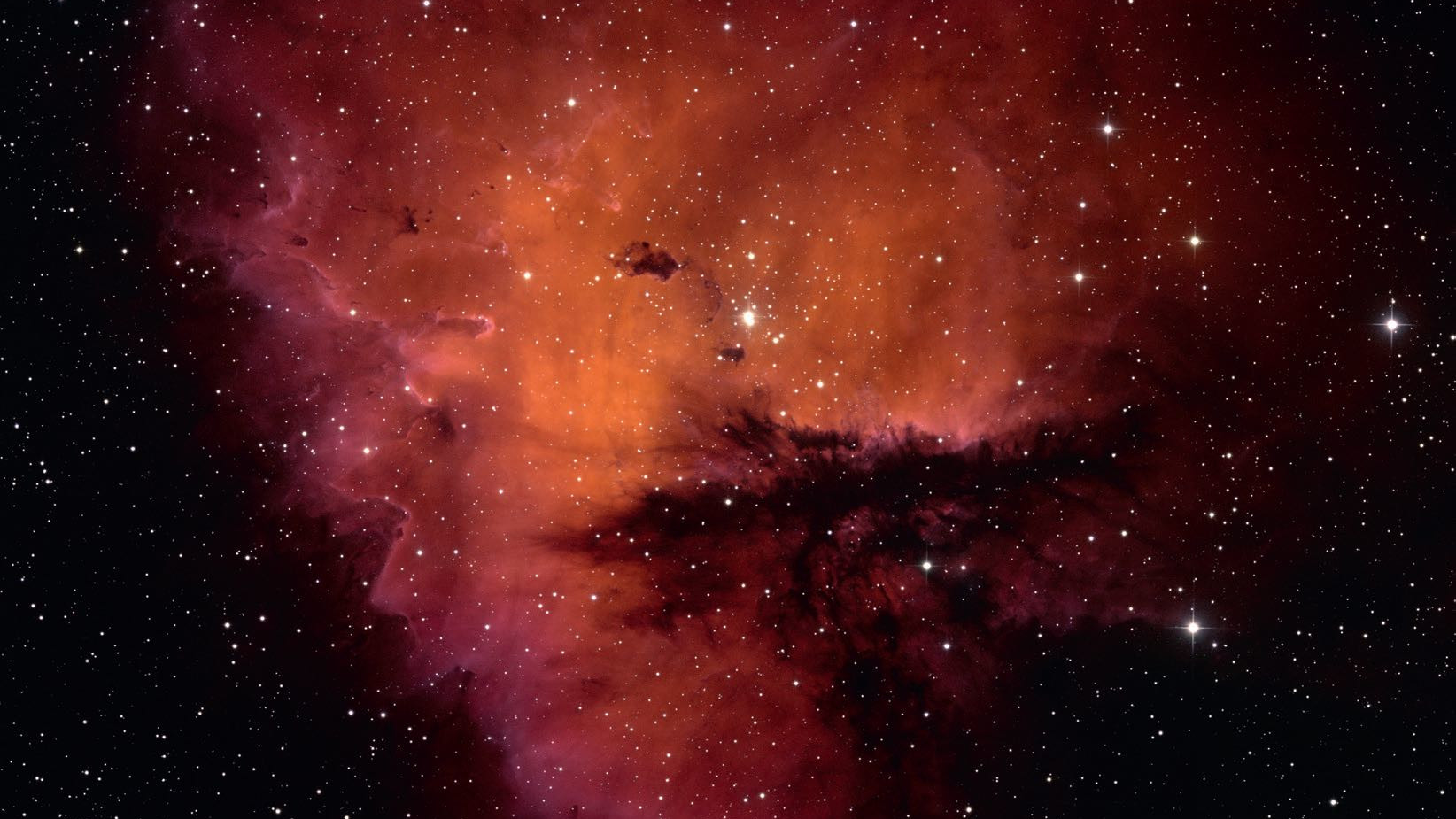 A forma de NGC 281 faz lembrar a figura de Pacman não só fotograficamente, mas também visualmente. NSF/AURA/WIYN/T. Rector (University of Alaska) 
